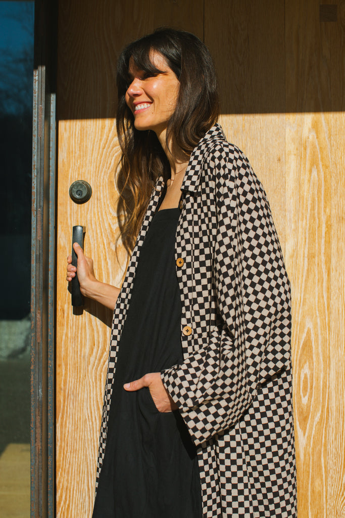 Elevate your style with this eye-catching red duster jacket, adorned with coconut buttons for a touch of natural charm. Crafted from high-quality block print fabric, this jacket boasts a timeless black and white checkered pattern, adding sophistication to any ensemble