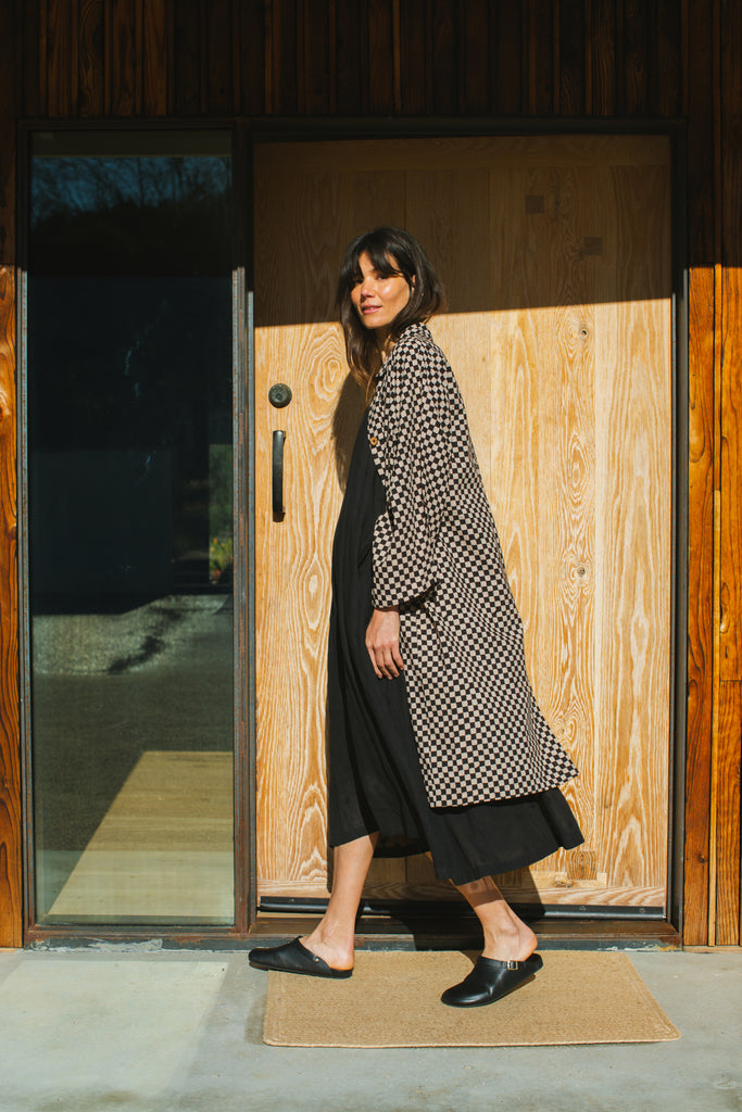 Elevate your style with this eye-catching red duster jacket, adorned with coconut buttons for a touch of natural charm. Crafted from high-quality block print fabric, this jacket boasts a timeless black and white checkered pattern, adding sophistication to any ensemble