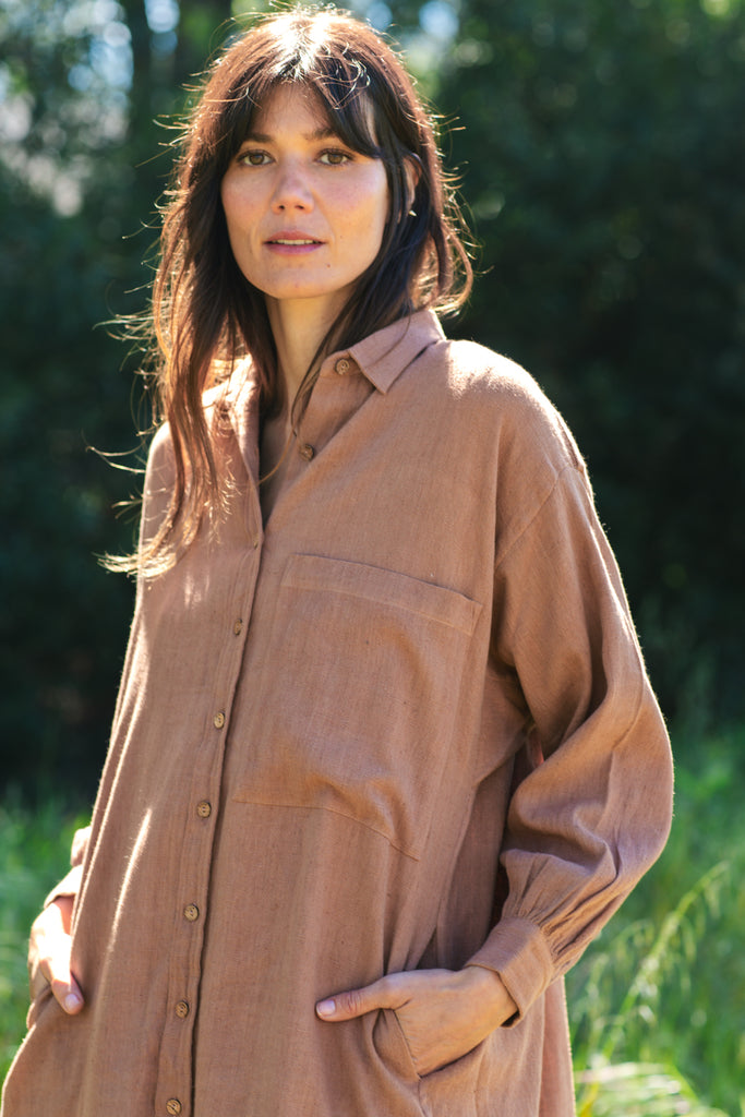 Indulge in the timeless appeal of this artist smock, tailored for both artists and creatives, as well as individuals seeking a stylish layer for their ensemble. The rich rusty brown hue adds a distinctive touch, seamlessly complementing any outfit for an elevated look. Featuring full sleeves, button closure, and a convenient front pocket, this smock offers both practicality and sophistication in one.