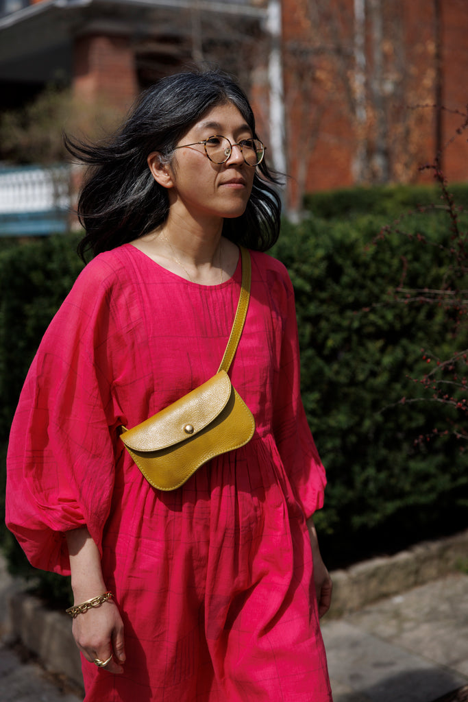 This Get Away Dress is made in a collaboration between Erica Kim @ahistoryofarchitecture and World of Crow, the dress has a scoop neck, barbie pink color, light checks in jamdani fabric