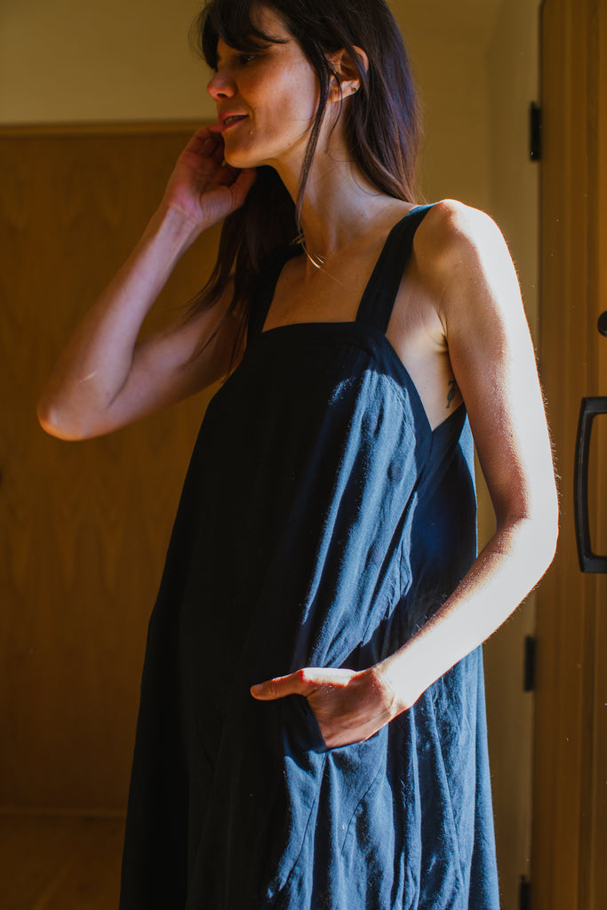 This Everywhere dress is made in collaboration between Erica Kim and World of Crow, it's sleeveless, black in color, Jamdani fabric, Midi length, Sustainably made