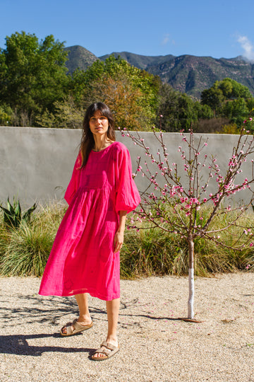 This Get Away Dress is made in a collaboration between Erica Kim @ahistoryofarchitecture and World of Crow, the dress has a scoop neck, barbie pink color, light checks in jamdani fabric