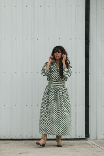 Green and white hand block-printed skirt made from 100% organic cotton, featuring a soft, lightweight fabric with azo-free dyes. Designed with a comfortable elasticated waist, full lining, and side pockets, this ethically made skirt falls 36” from the waist and fits true to size with a relaxed drape over the hips and legs. Each piece is uniquely handcrafted, with natural variations in color and pattern that reflect its artisanal charm—ideal for effortless, everyday wear.