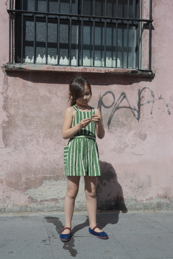 Green and white striped sleeveless dress with a halter neckline, gathered waist, and a relaxed fit.