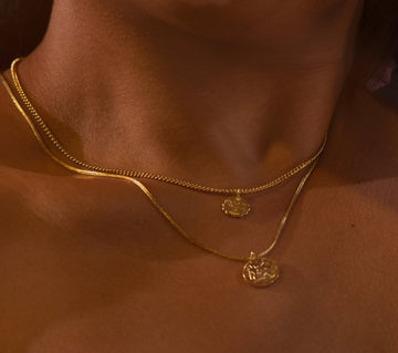 Introducing the Vintage Goddess Coin Necklace, featuring two coins on a 14K gold-plated curb chain. Made from recycled brass, this necklace combines timeless elegance with modern sustainability. Crafted in NYC and LA, it’s a luxurious yet eco-friendly addition to your collection.