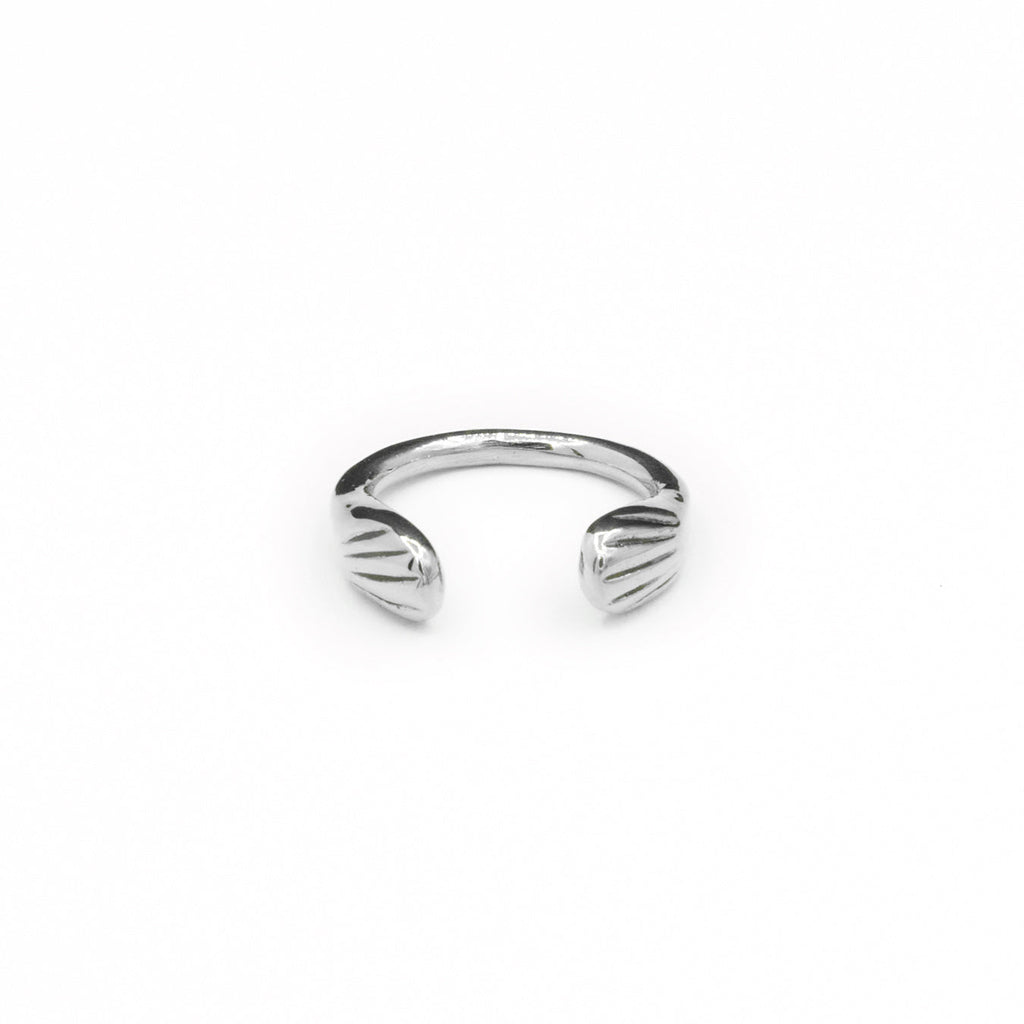 Introducing the sustainably hand-casted silver ring from the Mana Made x CCE Collection, featuring a distinctive wave design inspired by the sea. Crafted from recycled sterling silver and brass, this adjustable ring fits sizes 6 to 9, embodying a commitment to both style and environmental responsibility.