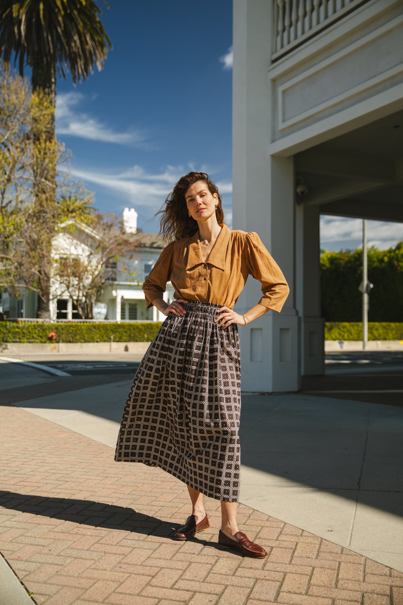 Black and white printed midi skirt with an elastic waistband, featuring a geometric pattern, flowy silhouette, and lightweight fabric for an effortlessly chic and comfortable style.
