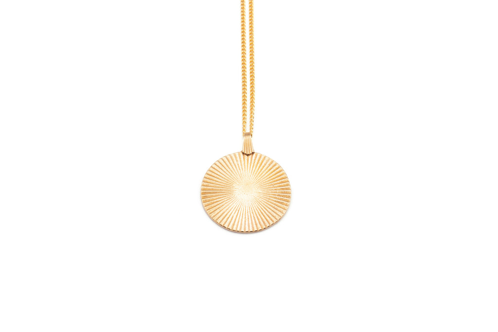 Introducing the Vintage-Inspired Gold Sunburst Pendant Necklace. This elegant gold disc features a sunburst design, gracefully suspended from a 21" chain. Choose between a 14K Gold Plated Curb Chain or a 14K Gold Filled Link Chain for a touch of customizable sophistication.