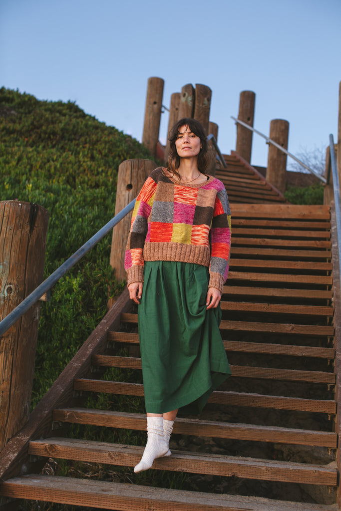 A Forest Green pull-on Skirt made from 100% handwoven cotton, this mid-rise skirt features an elasticated waistband and a straight mid-calf hem, offering a stylish and comfortable fit