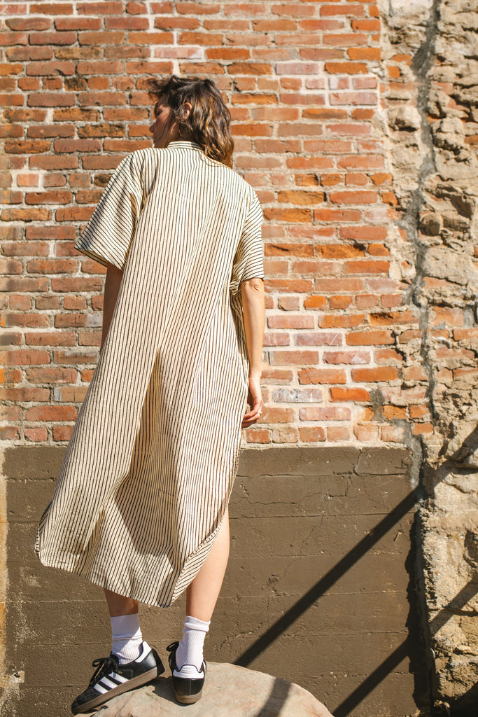 Black and white striped zebra-print shirt dress with a relaxed fit, lightweight breathable fabric, and subtle textured pattern for a stylish and comfortable look.