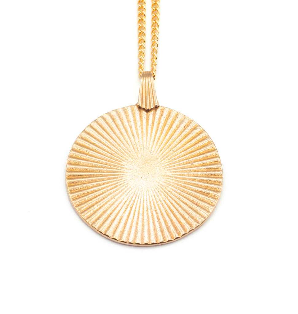 Introducing the Vintage-Inspired Gold Sunburst Pendant Necklace. This elegant gold disc features a sunburst design, gracefully suspended from a 21" chain. Choose between a 14K Gold Plated Curb Chain or a 14K Gold Filled Link Chain for a touch of customizable sophistication.