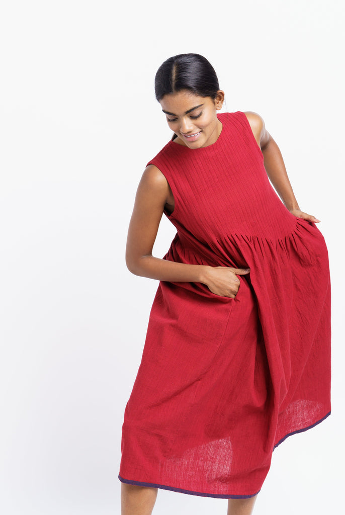 Red pleated midi dress, best ethical clothing brands India, best sustainable clothing brands, organic cotton wear, organic dresses online, cotton only clothing, cotton only clothing store, women's organic dresses, lightweight cotton women's clothing, clothing brands for minimalists, design minimalist wardrobe